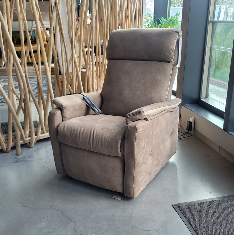 Fauteuil relax gris avec une t l commande pos e sur l'accoudoir dans un int rieur moderne pr s d'une grande fen tre et d'une cloison en bois d corative. Description g n r e par IA